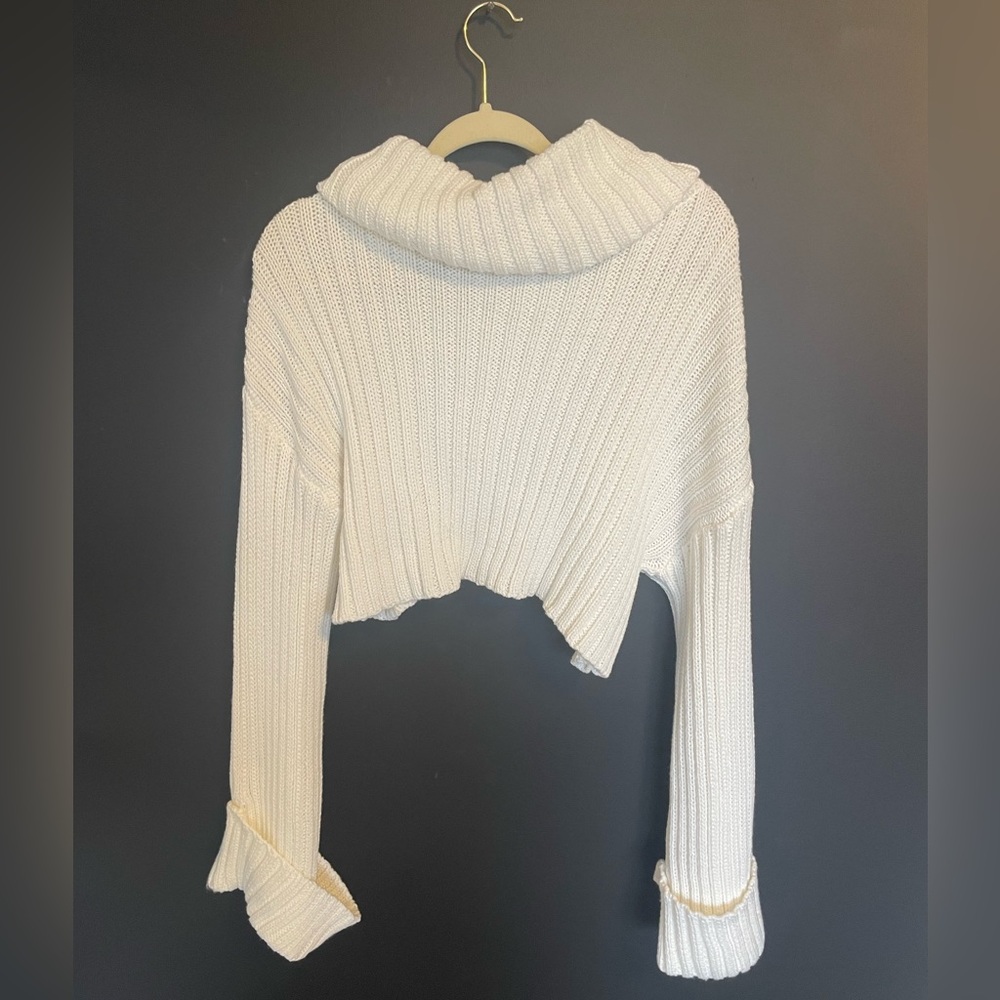 white cropped turtleneck sweater with flared sleeves